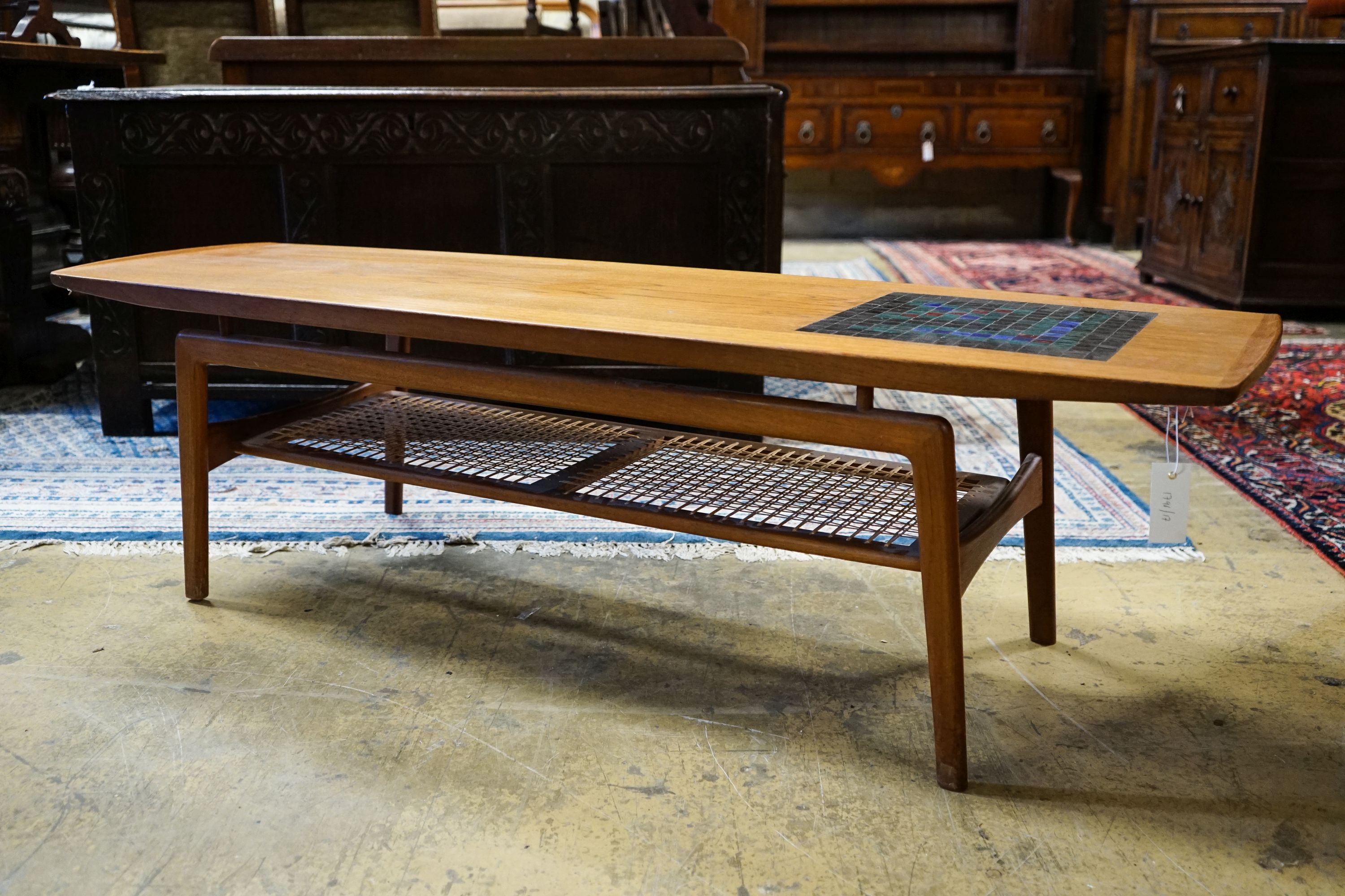 Arne Hovmand Olsen for Mogens Kold. A rectangular tiled top teak coffee table with caned undertier, length 148cm, depth 48cm, height 42cm
